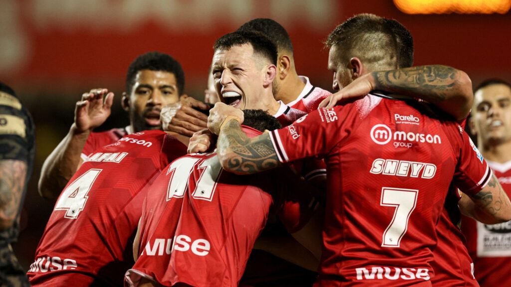 Picture by Paul Currie/SWpix.com - 27/09/2024 - Rugby League - Betfred Super League Eliminator - Salford Red Devils v Leigh Leopards - Salford Stadium, Eccles, England - Salford Red Devils' Deon Cross celebrates after Leigh Leopards' Darnell McIntosh is dragged over the try line