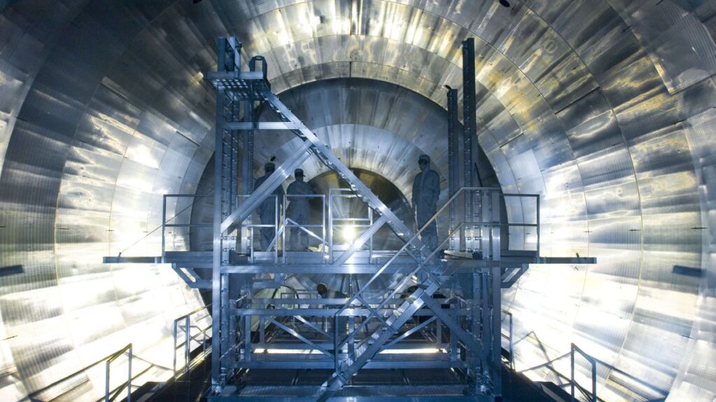 Engineers stand inside the KATRIN neutrino experiment at the Karlsruhe Institute of Technology in Germany.