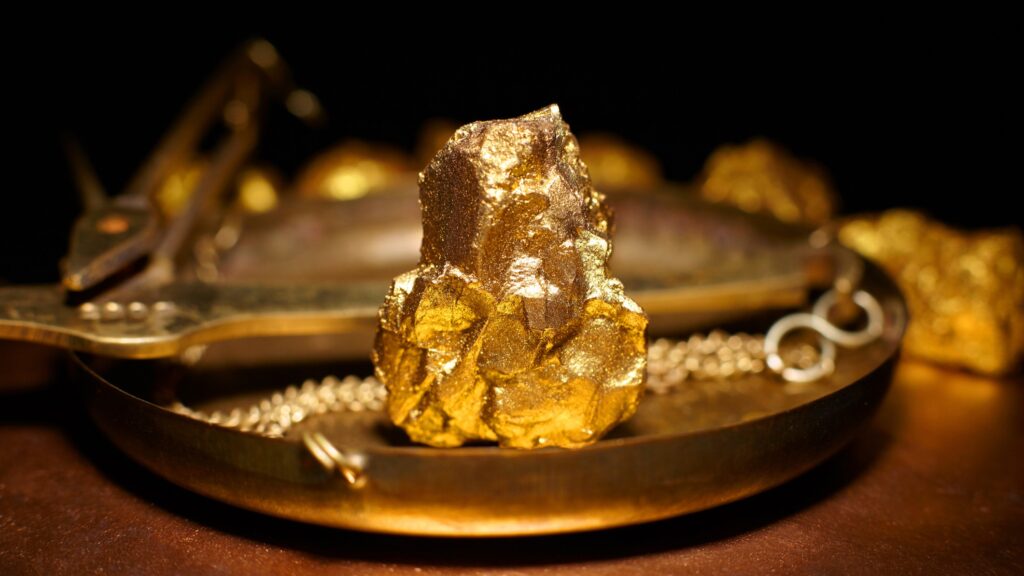 A large gold nugget on copper scales.