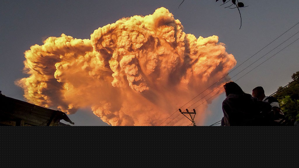 A giant ash plume from Mount Lewoboti Laki-laki in Indonesia. The ash appears orange.